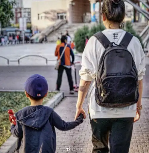靳东妻子晒两娃背影照小儿子戴帽子呆萌可爱
